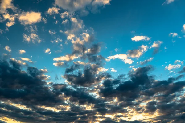 The heavenly light of the sun. Dramatic evening sky with clouds and rays of the sun. Sunlight at evening sunset or morning dawn.Panoramic view of the blue sky with clouds in motion. Blue skies