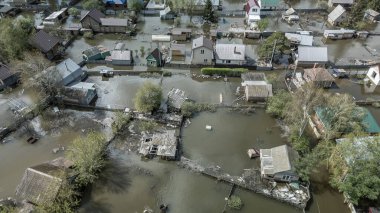 Büyük bir şehrin su altında evleri ve caddeleri olan insansız hava aracı görüntüleri. Şiddetli hava ve sağanak yağış kaynaklı kentsel sel, yerleşim alanları üzerinde doğal afet etkisi gösteriyor. İklim değişikliği
