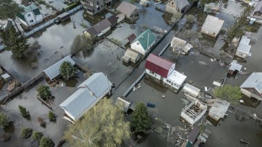 Büyük bir şehrin su altında evleri ve caddeleri olan insansız hava aracı görüntüleri. Şiddetli hava ve sağanak yağış kaynaklı kentsel sel, yerleşim alanları üzerinde doğal afet etkisi gösteriyor. İklim değişikliği