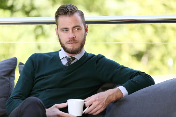 Well dressed man sitting down outside — Stock Photo, Image