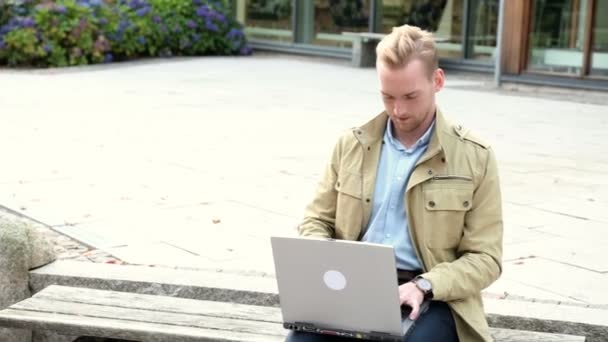 Homem atraente sentado do lado de fora — Vídeo de Stock