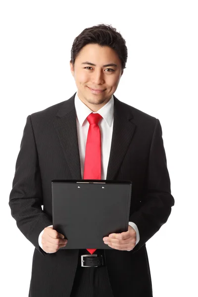 Attractive businessman with clipboard — Stock Photo, Image