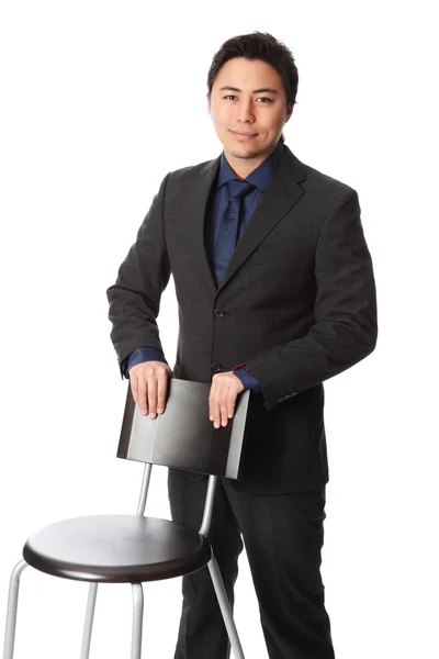 Businessman with chair — Stock Photo, Image