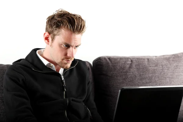 Focused young man with laptop — Stock Photo, Image