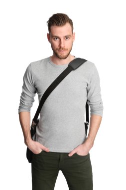 Young man in a gray shirt standing on a white background, wearing a computer bag on his shoulder. clipart