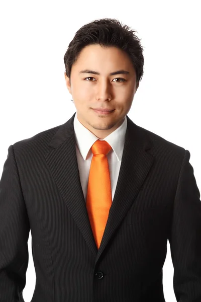 Businessman in orange tie and suit — Stock Photo, Image