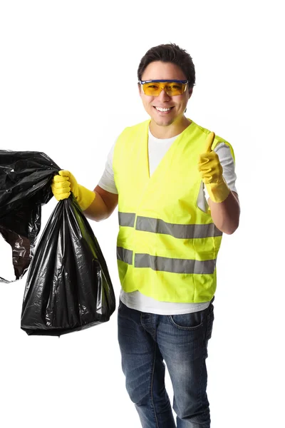 Homem segurando um saco de lixo com roupas de segurança — Fotografia de Stock