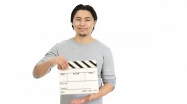 Young handsome man holding a movie clapper