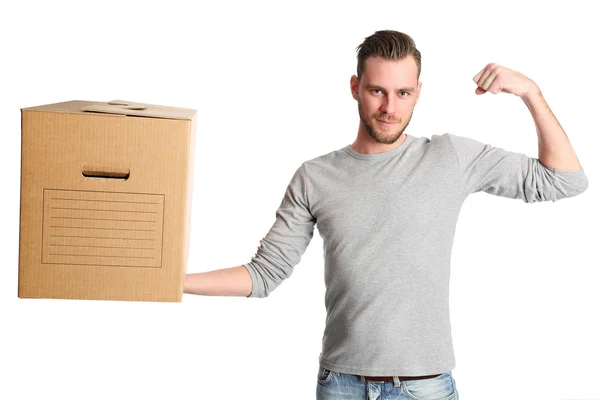 Flexing man with cardboardbox — Stok fotoğraf