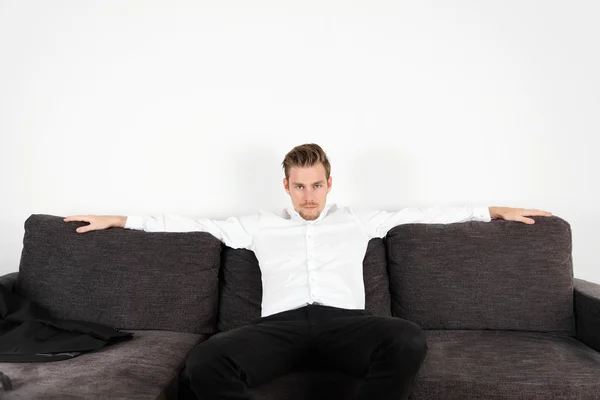 Relaxed man sitting down — Stock Photo, Image