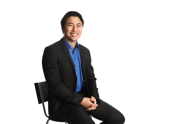 Uomo d'affari con un completo seduto — Foto Stock