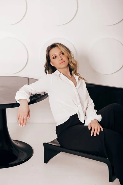 Ελκυστική σέξι γυναίκα φορούν επιχειρηματικό βλέμμα. Οι γυναίκες φαίνονται σέξι και αισθησιακές. μοντέλο φορούν λευκό πουκάμισο και μαύρο παντελόνι. — Φωτογραφία Αρχείου