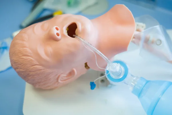 A medical training manikin on a table for medical students, anaesthetists and anaesthesiologists to practice endotracheal intubation.