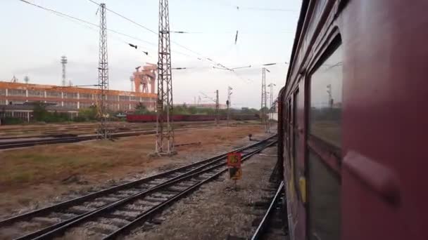 Old train entering a vintage industrial port with cranes visible in the background — Video Stock