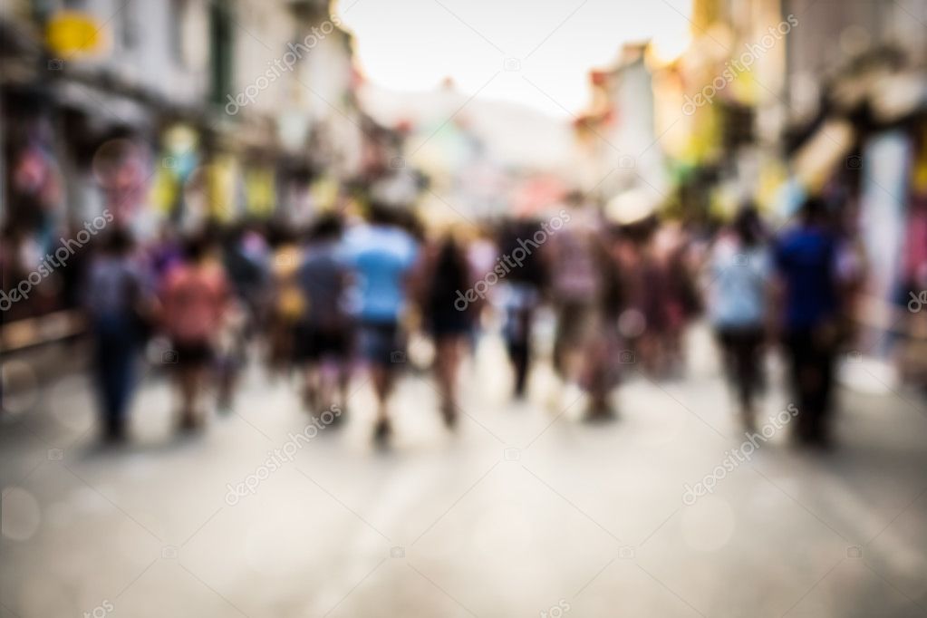 Blurred people walking on the street