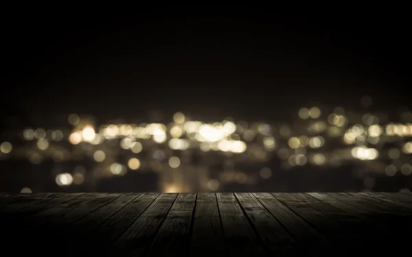 Wooden plank above the town at night — Stock Photo, Image