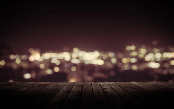 Wooden plank above the town at night — Stock Photo, Image