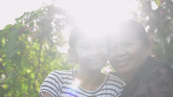 Asian Happy Senior Grandmother Adorable Teen Granddaughter Posing Hugs Each — Stock Video