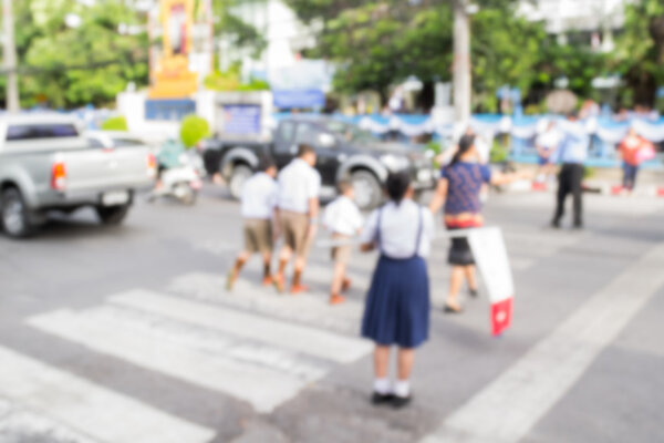 Blurred schoolchild walk crossing the street