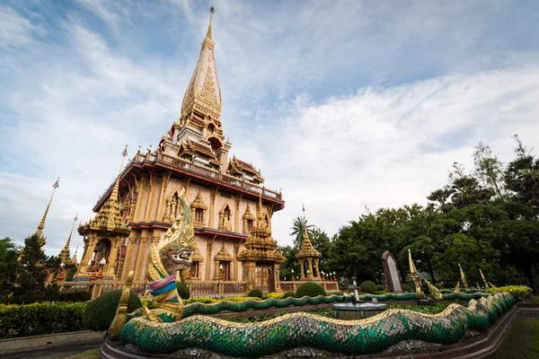 Naga sculpture in the garden with holy pagoda of chalong temple — Stock Photo, Image