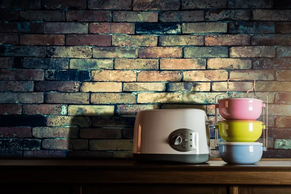 Colorful tiffin carrier and toaster on wooden cupboard with vint — Stock Photo, Image