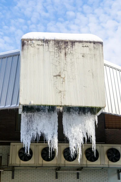 Large icicles hanging from industrial drains — Stock Photo, Image