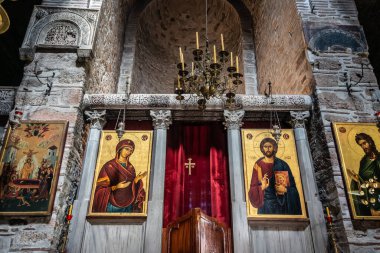 The golden murals with paintings of christ, mary and the apostles on the dome ceiling of Hosios Loukas monastery in Greece.