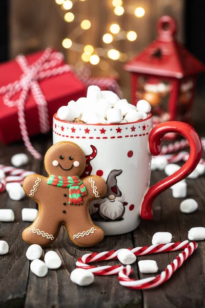 Cup of creamy hot chocolate with melted marshmallows and  gingerbread cookies   for christmas holiday, selective focus, shallow depth of field