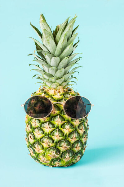  Pineapple  in sunglasses, stylish fruit. Minimal concept, summer tropical pineapple. Creative  fashionable vacation concept. Summertime vacation mood, pineapple fruit
