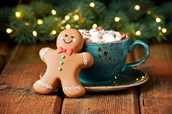 Cup of creamy hot chocolate with melted marshmallows and  gingerbread cookies   for christmas holiday, selective focus, shallow depth of field