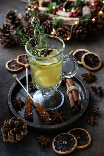 Winter hot drink with lemon in glass. Christmas and winter warming beverage