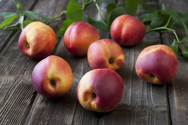 Nectarines on wooden table in a rustic style — Stock Photo, Image