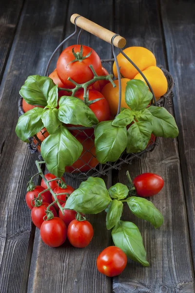 Sweet ripe tomatoes on wooden table — Stock Photo, Image