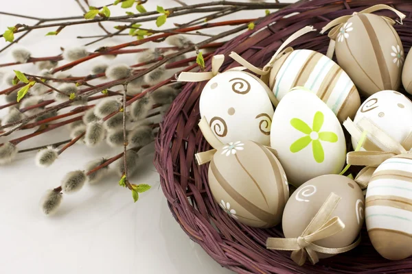 Easter eggs in wicker basket — Stock Photo, Image