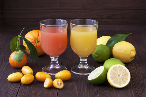 Fresh fruit juices on wooden table — Stock Photo, Image