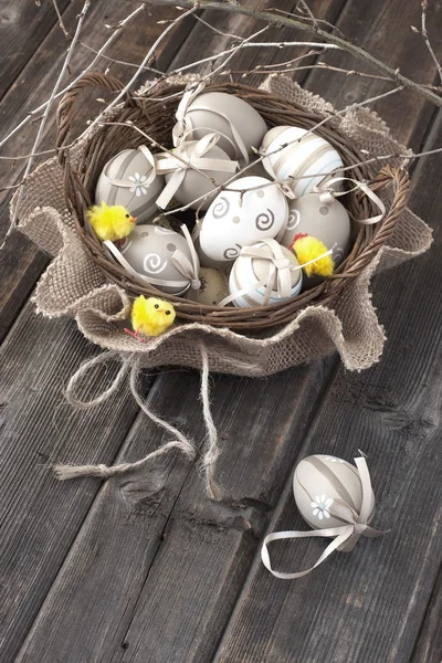 Colorful easter eggs in  wicker  basket — Stock Photo, Image