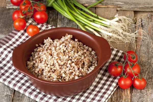 Buckwheat cereal in  bowl on wooden  table — Stock Photo, Image