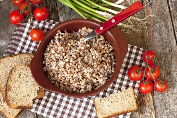 Buckwheat cereal in  bowl on wooden  table — Stock Photo, Image