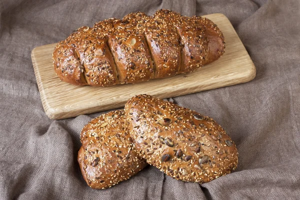 Freshly baked traditional bread on wooden board — Stock Photo, Image