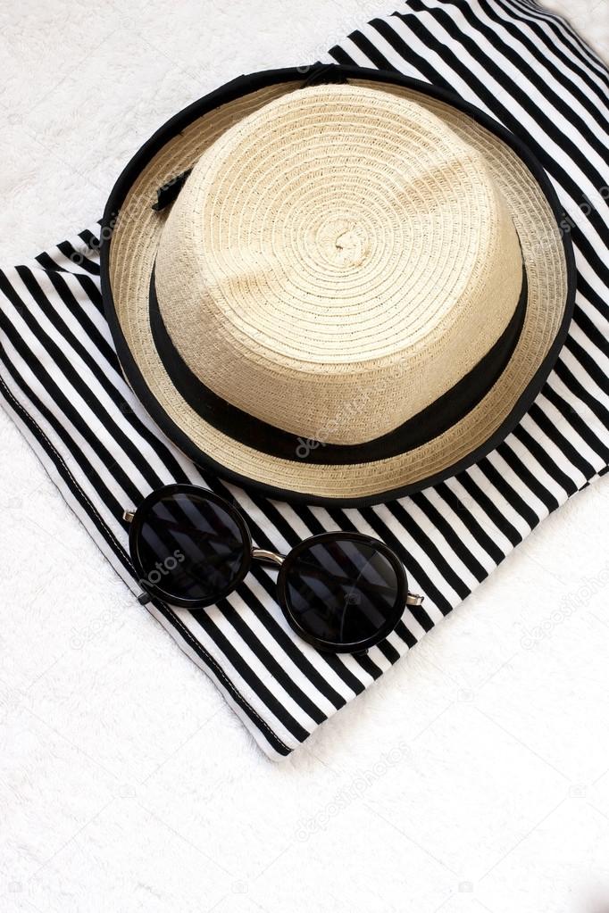 Beach items with straw hat,towel and sunglasses
