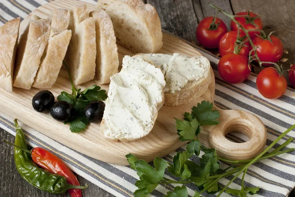 Tasty baguette  with cheese cream  a wooden board — Stock Photo, Image