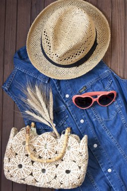 Beach bag, sunglasses  and  hat  on  wooden background