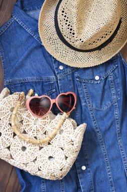 Beach bag, sunglasses  and  hat  on  wooden background