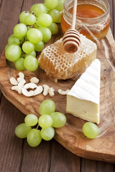 Cheese camembert with honey and nuts served with grape — Stock Photo, Image