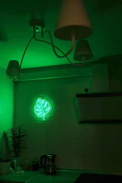 Neon sign monstera in the decor of the kitchen. Trendy style. Neon sign. Custom neon. Home decor.