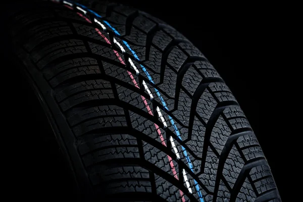 Car tires. Winter wheel profile structure on black background — Stock Photo, Image