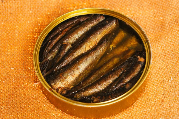 Open can with of sprats on sackcloth background — Stock Photo, Image