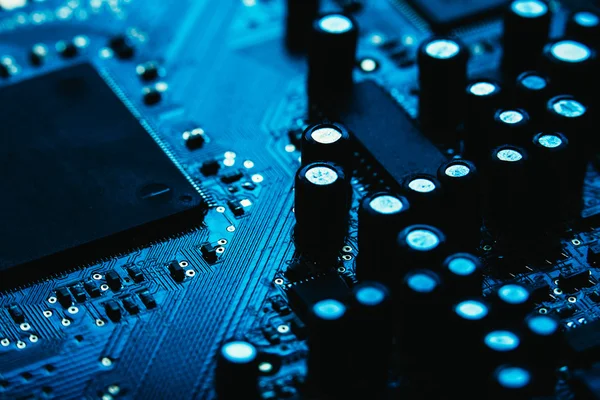 Computer motherboard closeup blue color on dark background — Stock Photo, Image