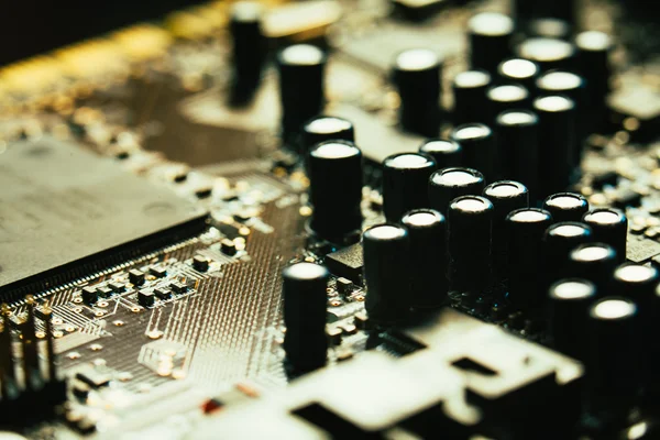 Computer motherboard closeup yellow gray color on dark background — Stock Photo, Image