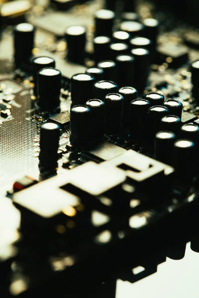 Computer motherboard closeup yellow gray color on dark background — Stock Photo, Image